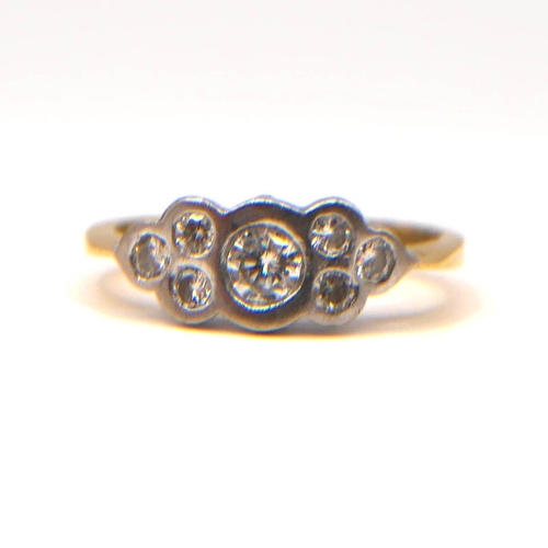 35 - A VINTAGE YELLOW AND WHITE METAL SEVEN STONE DIAMOND RING
The central brilliant round cut diamond (a... 