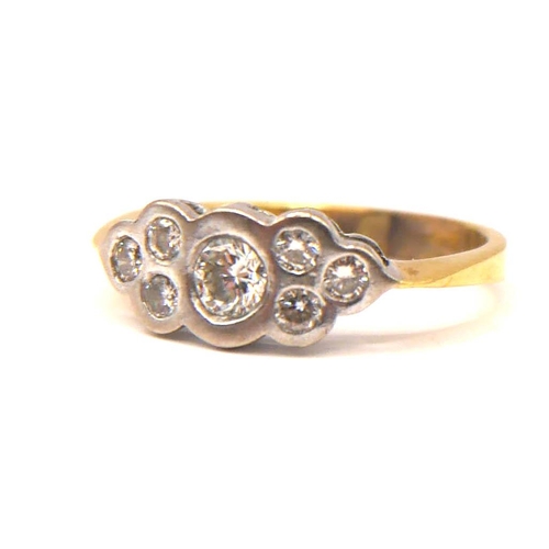 35 - A VINTAGE YELLOW AND WHITE METAL SEVEN STONE DIAMOND RING
The central brilliant round cut diamond (a... 