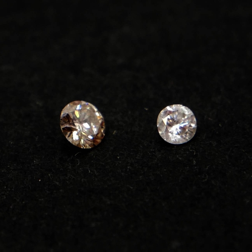 43A - TWO LOOSE UNMOUNTED ROUND BRILLIANT CUT DIAMONDS, BOXED.
(0.08ct/0.16ct)