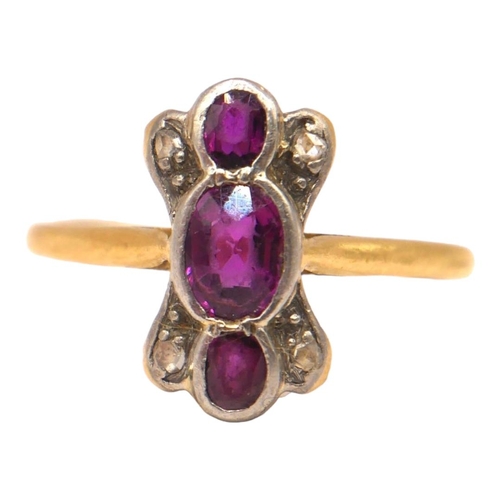 49 - A 20TH CENTURY YELLOW METAL, RUBY AND DIAMOND RING
Having three oval cut rubies (largest approx. 5mm... 