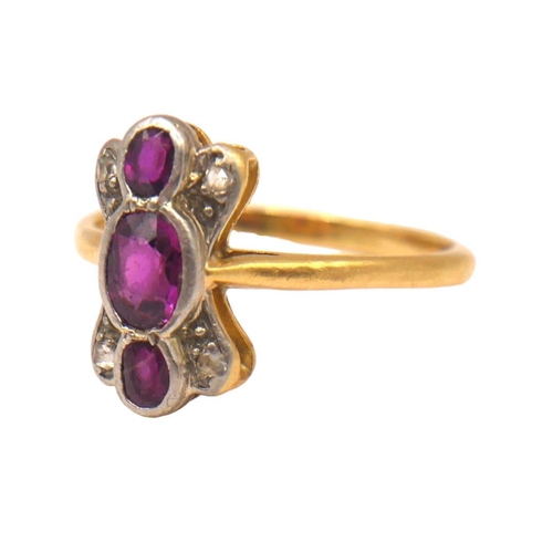 49 - A 20TH CENTURY YELLOW METAL, RUBY AND DIAMOND RING
Having three oval cut rubies (largest approx. 5mm... 