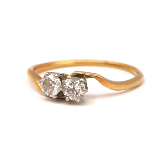 50 - AN 18CT YELLOW GOLD AND PLATINUM TWO STONE DIAMOND CROSSOVER RING
Old European round cut diamonds (a... 