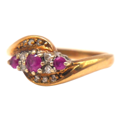 8 - A 9CT GOLD, RUBY AND DIAMOND CROSSOVER RING
The central round cut ruby (approx diameter 3mm) flanked... 