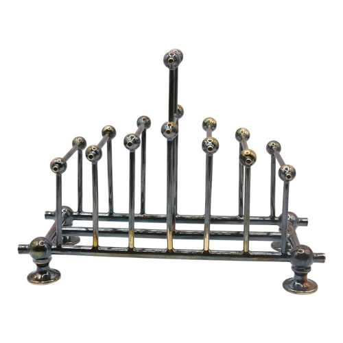 81 - AFTER CHRISTOPHER DRESSER, A LATE 19TH CENTURY SILVER PLATED TOASTRACK
Six sections decorated with a... 