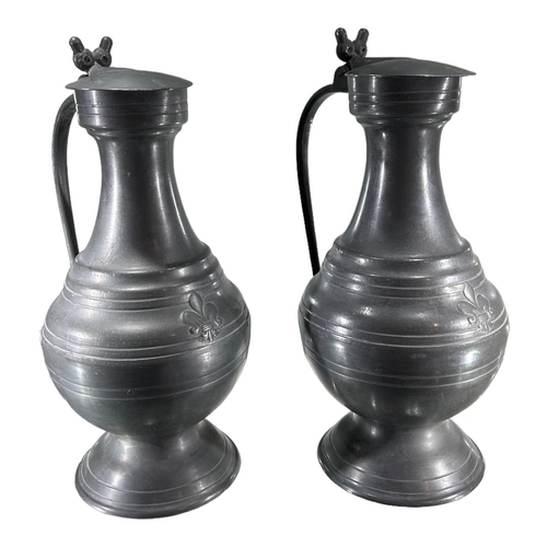 102A - A LARGE PAIR OF 19TH CENTURY FRENCH PEWTER TAPPIT HENSHaving fleur-de-lis and banded decoration and ... 