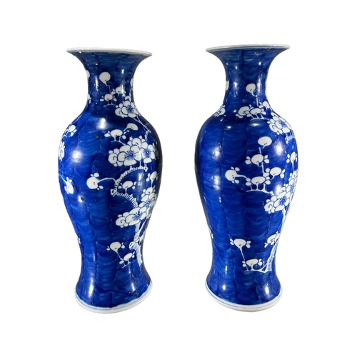 116 - PAIR OF 19TH CENTURY CHINESE QING DYNASTY BLUE AND WHITE VASESDecorated with prunus blossom on blue ... 