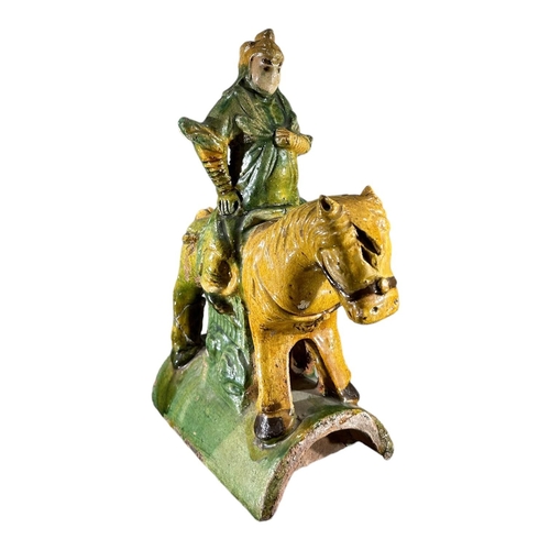 140 - A 19TH CENTURY CHINESE QING DYNASTY SANCAI GLAZED EQUESTRIAN ROOF TILEShowing a man on horseback in ... 