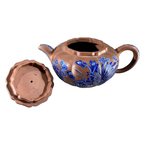 144 - A CHINESE YIXING CLAY TEAPOT WITH BLUE ENAMELLED DECORATIONShowing blue floral decoration and Dog of... 