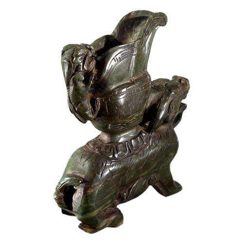 166 - A CHINESE CARVED GREEN SOAPSTONE QILIN VESSEL. (h 17.5cm x w 14cm x d 3.5cm)