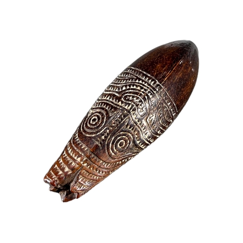 170 - ELEMA, PAPUA NEW GUINEA. LATE 19TH/ EARLY 20TH CENTURY CARVED COCONUT MARUPADI CHARM (POSSIBLY DEPIC... 