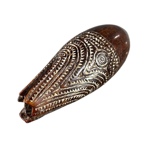 170 - ELEMA, PAPUA NEW GUINEA. LATE 19TH/ EARLY 20TH CENTURY CARVED COCONUT MARUPADI CHARM (POSSIBLY DEPIC... 