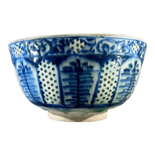 173 - A 17TH CENTURY SAFAVID GOMBROON POTTERY BOWLDecorated with slipware translucent holes, spaced in bet... 