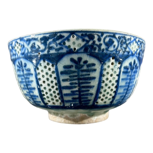 173 - A 17TH CENTURY SAFAVID GOMBROON POTTERY BOWLDecorated with slipware translucent holes, spaced in bet... 