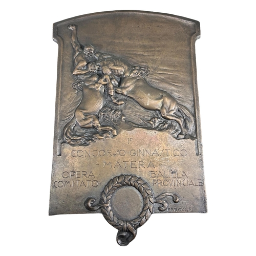 200A - A 20TH CENTURY ITALIAN BRONZE PLAQUE SHOWING TWO FIGHTING CENTAURS, COMMEMORATING MATERA GYMNASTICS ... 