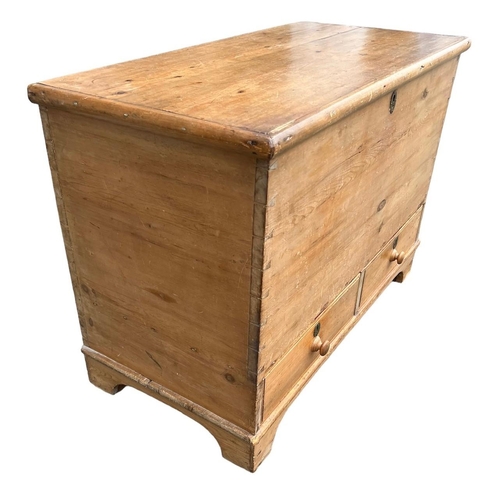 242 - A 19TH CENTURY STRIP AND WAXED PINE MULE CHESTWith hinged lid above two drawers, raised on bracket f... 