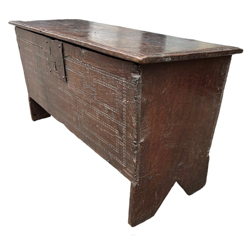 244 - A SMALL 17TH CENTURY OAK COFFER With hinge lid above a carved panel.(h 48cm x d 35cm x w 90.5cm)