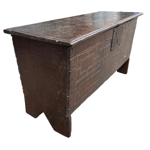 244 - A SMALL 17TH CENTURY OAK COFFER With hinge lid above a carved panel.(h 48cm x d 35cm x w 90.5cm)