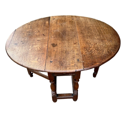 246 - AN 18TH CENTURY OAK GATELEG TABLE The single drawer, raised on turned legs joined by stretcher. (h 7... 