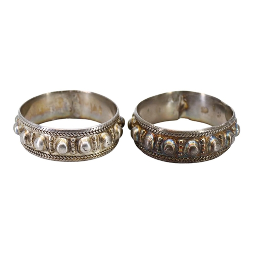 61 - A PAIR OF LATE 19TH/EARLY 20TH CENTURY OMANI SILVER FERTILITY BRACLETS (BANAGIRI BU NUJUM/BANAGIRI M... 