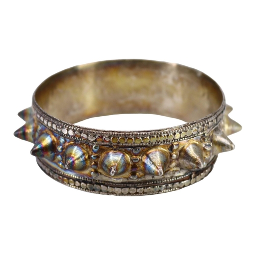 62 - A PAIR OF LATE 19TH EARLY 20TH CENTURY OMANI SILVER ELBOW-RINGS, TOGETHER WITH OMANI SILVER FERTILIT... 