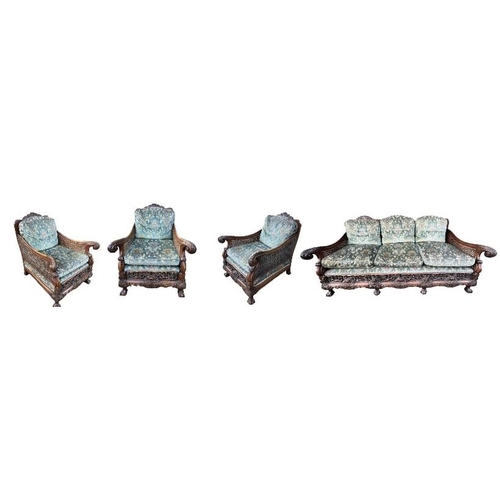 223 - A GOOD LATE 19TH/EARLY 20TH CENTURY CARVED MAHOGANY BERGERE SUITEComprising a double caned three sea... 