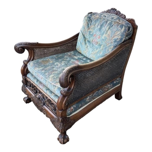 223 - A GOOD LATE 19TH/EARLY 20TH CENTURY CARVED MAHOGANY BERGERE SUITEComprising a double caned three sea... 