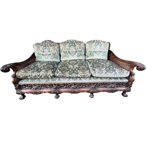 223 - A GOOD LATE 19TH/EARLY 20TH CENTURY CARVED MAHOGANY BERGERE SUITEComprising a double caned three sea... 