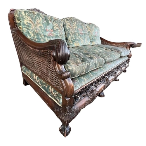 223 - A GOOD LATE 19TH/EARLY 20TH CENTURY CARVED MAHOGANY BERGERE SUITEComprising a double caned three sea... 