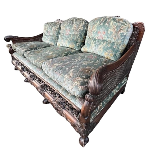 223 - A GOOD LATE 19TH/EARLY 20TH CENTURY CARVED MAHOGANY BERGERE SUITEComprising a double caned three sea... 