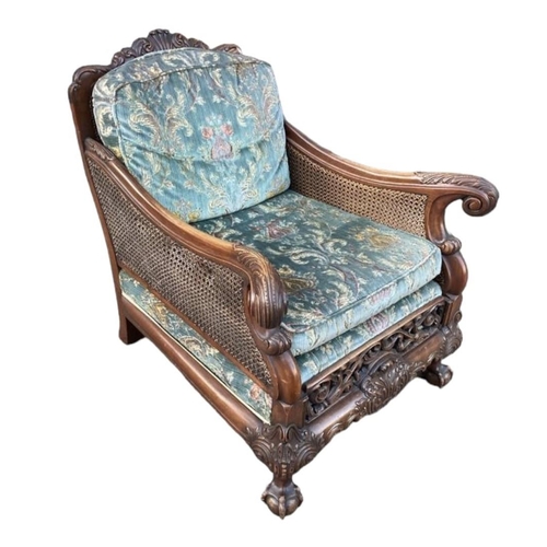 223 - A GOOD LATE 19TH/EARLY 20TH CENTURY CARVED MAHOGANY BERGERE SUITEComprising a double caned three sea... 