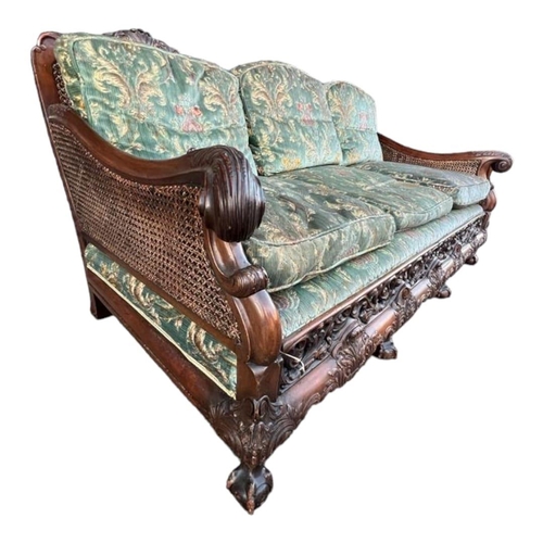 223 - A GOOD LATE 19TH/EARLY 20TH CENTURY CARVED MAHOGANY BERGERE SUITEComprising a double caned three sea... 