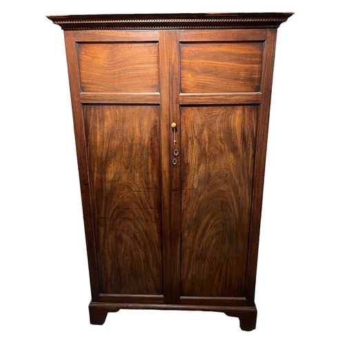 232 - A GEORGE III MAHOGANY TWO DOOR WARDROBEThe doors opening to reveal hanging rail the side fitted with... 