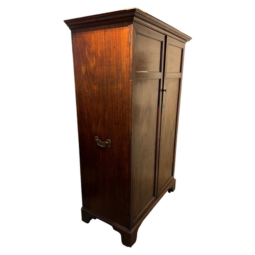 232 - A GEORGE III MAHOGANY TWO DOOR WARDROBEThe doors opening to reveal hanging rail the side fitted with... 