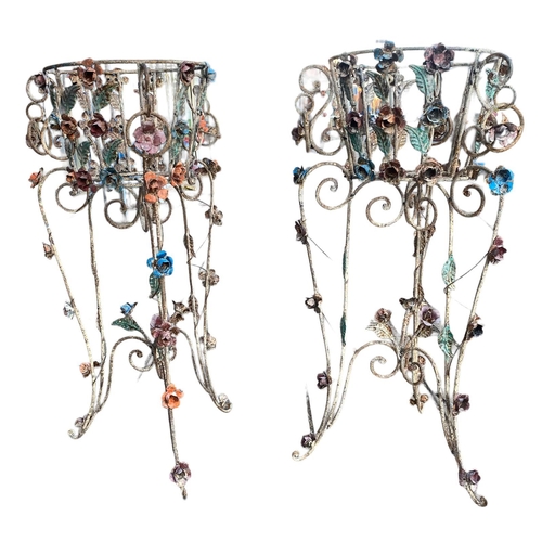 235 - A PAIR OF DECORATIVE WROUGHT IRON AND POLYCHROME FREESTANDING JARDINIÈRESDecorated with scrolling fo... 