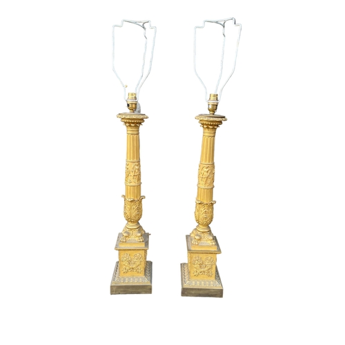 267 - A PAIR OF 19TH CENTURY FRENCH EMPIRE GILT BRONZE AND ORMOLU COLUMN LAMPS
Decorated with Grecian Godd... 