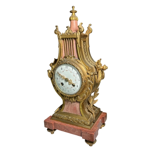 274A - A 19TH CENTURY FRENCH MARBLE AND GILT ORMOLU MANTEL CLOCK
Decorated with finely cast scroll and bow ... 