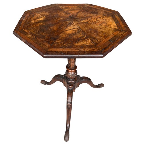 268 - A GEORGE II CARVED WALNUT TRIPOD TABLE
The octagonal top inlaid with burr wood supported on a carved... 