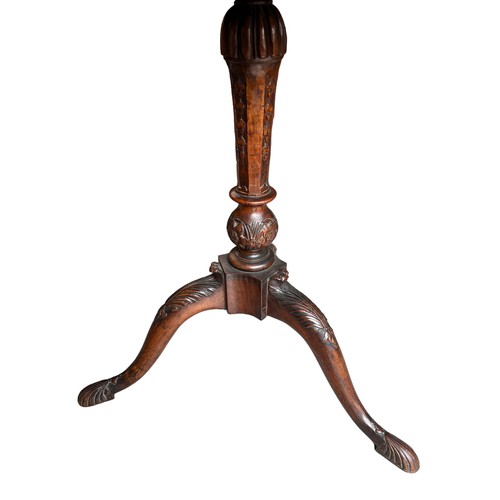 268 - A GEORGE II CARVED WALNUT TRIPOD TABLE
The octagonal top inlaid with burr wood supported on a carved... 