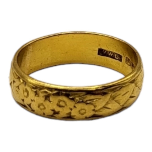 13 - A 22CT GOLD BAND
Having floral chased and engraved decoration. 
(size M½, 5.8g)