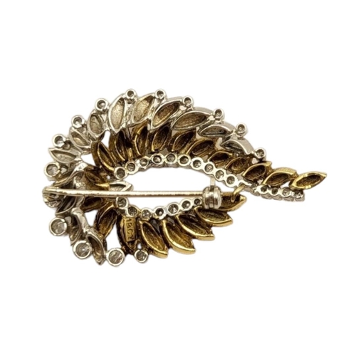 16 - A VINTAGE 18CT YELLOW AND WHITE GOLD DESIGNER STYLE LEAF BROOCH
Mounted with white sapphires, thirty... 