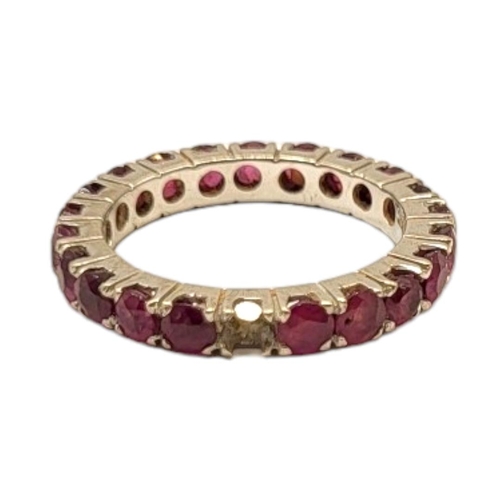 28 - A VINTAGE 14CT WHITE GOLD AND RUBY ETERNITY RING
The round cut rubies (approx. 3mm each) set in claw... 