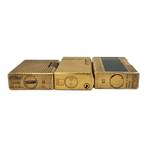 41 - ST. DUPONT, PARIS, TWO LIGNE 1 AND LIGNE 2 GOLD PLATED LIGHTERS 
Together with gold plated Dunhill l... 