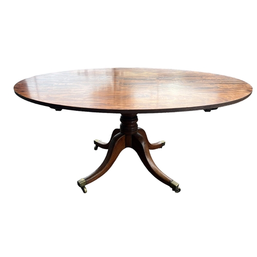 204 - A 19TH CENTURY FLAME MAHOGANY OVAL TILT TOP BREAKFAST TABLE
Supported on a turned pedestal base, ter... 