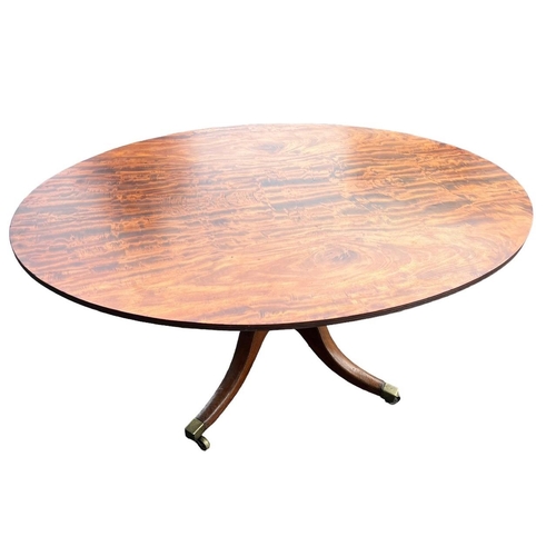 204 - A 19TH CENTURY FLAME MAHOGANY OVAL TILT TOP BREAKFAST TABLE
Supported on a turned pedestal base, ter... 