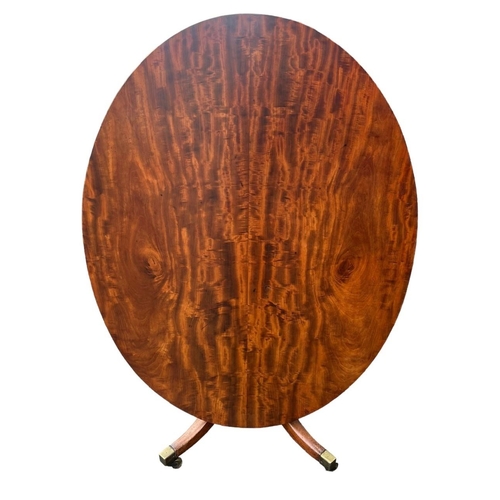 204 - A 19TH CENTURY FLAME MAHOGANY OVAL TILT TOP BREAKFAST TABLE
Supported on a turned pedestal base, ter... 