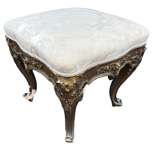 212 - GILLOWS, A 19TH CENTURY CARVED WALNUT CIRCULAR FOOTSTOOL
The upholstered top, raised on four cabriol... 