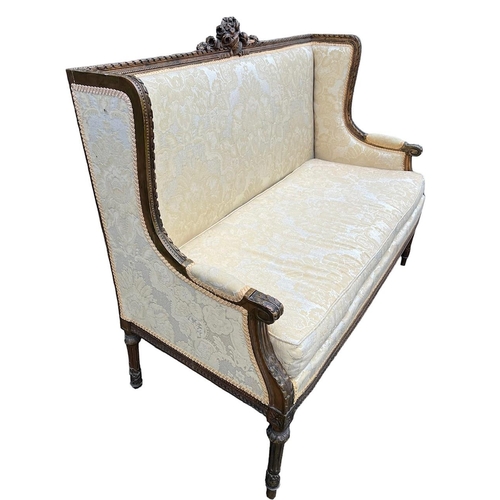 216 - A 19TH CENTURY FRENCH LOUIS XVI DESIGN CARVED GILTWOOD WINGBACK SETTEE
The back carved with a centra... 