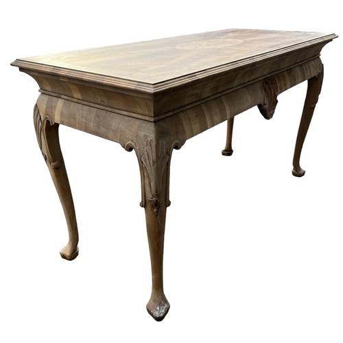 232 - MANNER OF DAVID LINLEY, A GEORGE II DESIGN WALNUT AND OYSTER VENEERED SERVING TABLE
The inlay top ra... 