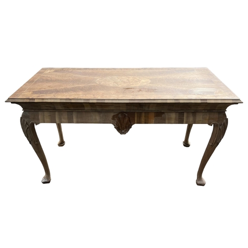 232 - MANNER OF DAVID LINLEY, A GEORGE II DESIGN WALNUT AND OYSTER VENEERED SERVING TABLE
The inlay top ra... 