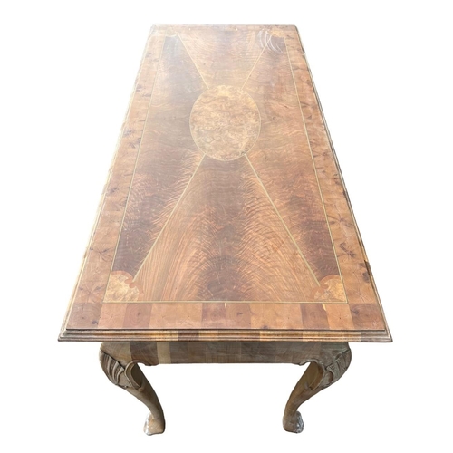 232 - MANNER OF DAVID LINLEY, A GEORGE II DESIGN WALNUT AND OYSTER VENEERED SERVING TABLE
The inlay top ra... 